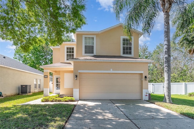 traditional-style house with concrete driveway, fence, and stucco siding