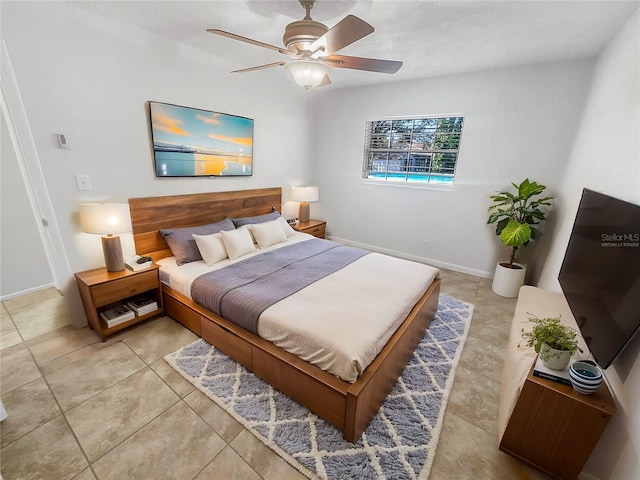 bedroom featuring ceiling fan, baseboards, and light tile patterned floors