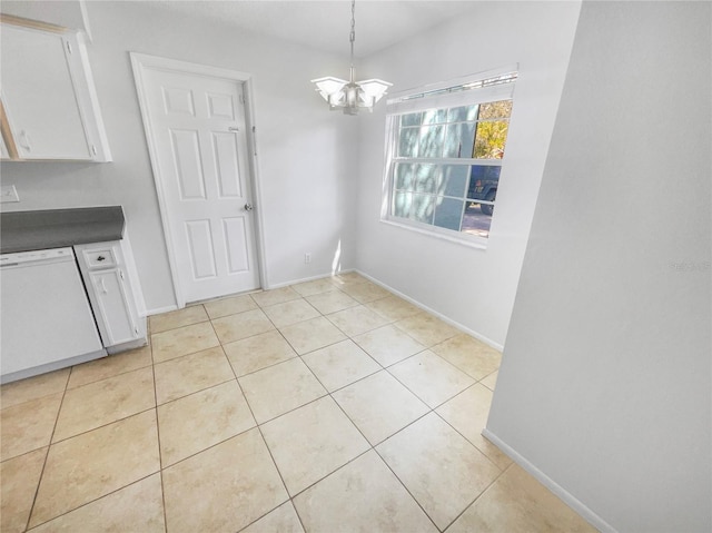 unfurnished dining area with light tile patterned floors, baseboards, and a notable chandelier