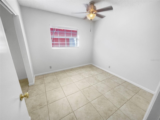 unfurnished room featuring baseboards and a textured ceiling