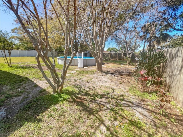 view of yard with a fenced in pool and a fenced backyard