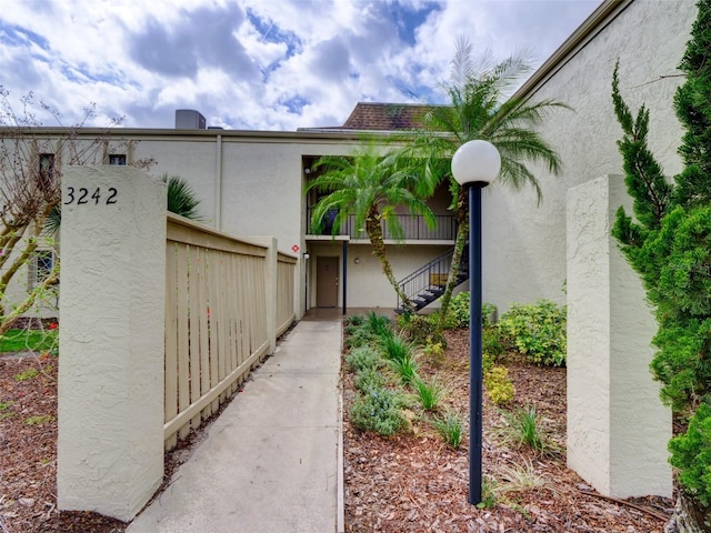 exterior space featuring fence and stucco siding