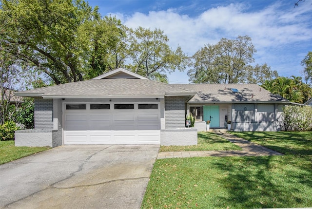 ranch-style house featuring a garage, driveway, brick siding, and a front yard