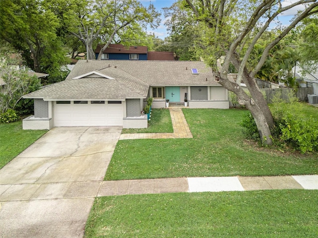 view of front facade featuring a garage, brick siding, driveway, roof with shingles, and a front yard