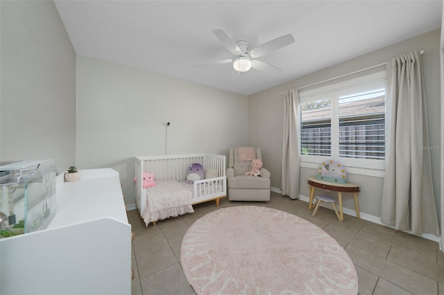 tiled bedroom featuring ceiling fan and baseboards