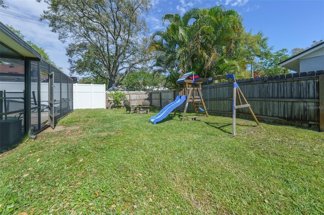 view of yard featuring a fenced backyard and a playground