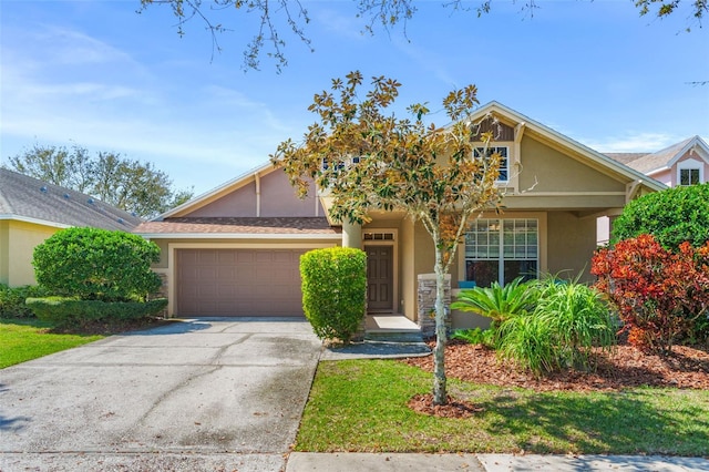 view of front of house featuring driveway, an attached garage, and stucco siding