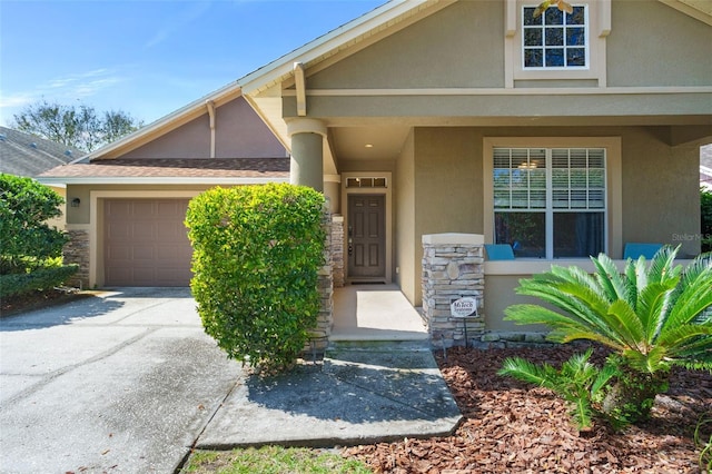 view of front of property with driveway, a shingled roof, stone siding, an attached garage, and stucco siding