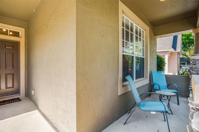 entrance to property featuring stucco siding