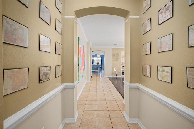 12824 Penshurst Ln, Windermere, FL 34786 - hallway with arched walkways, light tile patterned floors, ornamental molding, and baseboards