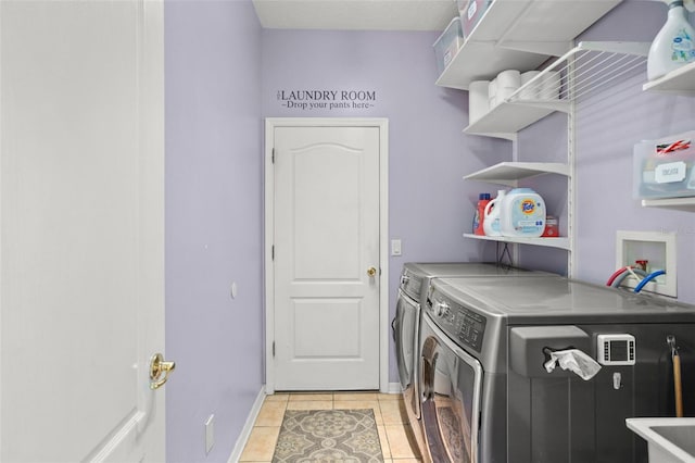 12824 Penshurst Ln, Windermere, FL 34786 - laundry room with light tile patterned floors, laundry area, washing machine and clothes dryer, and baseboards