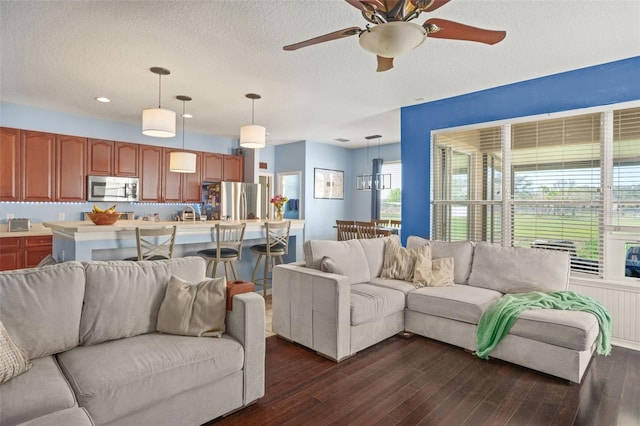 12824 Penshurst Ln, Windermere, FL 34786 - living area with dark wood-style flooring, ceiling fan, and a textured ceiling