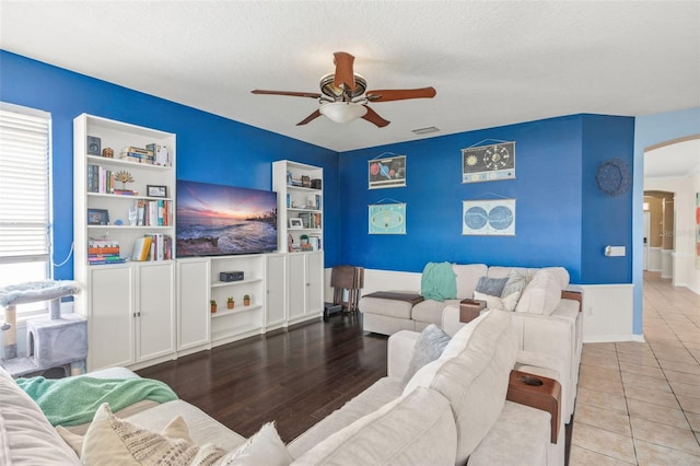 12824 Penshurst Ln, Windermere, FL 34786 - living room featuring a ceiling fan, visible vents, arched walkways, and a textured ceiling