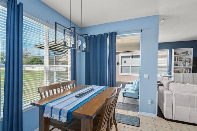 12824 Penshurst Ln, Windermere, FL 34786 - dining room featuring a healthy amount of sunlight, light tile patterned floors, baseboards, and a textured ceiling