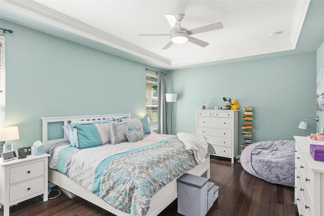 12824 Penshurst Ln, Windermere, FL 34786 - bedroom featuring ceiling fan, a tray ceiling, dark wood finished floors, and crown molding
