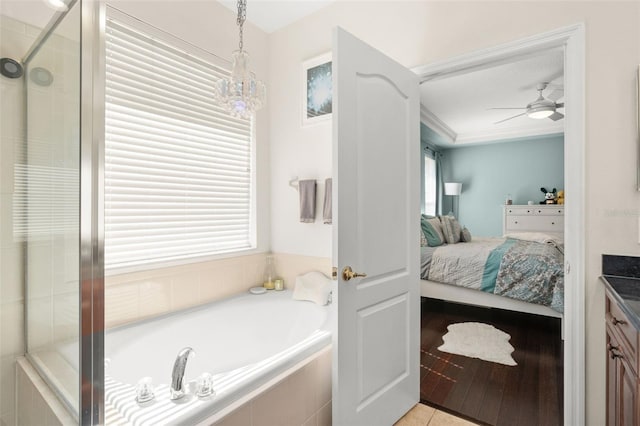 12824 Penshurst Ln, Windermere, FL 34786 - full bathroom featuring ceiling fan, a garden tub, a tile shower, ensuite bath, and crown molding
