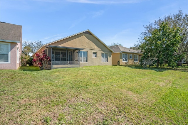12824 Penshurst Ln, Windermere, FL 34786 - back of property featuring a lawn, a sunroom, and stucco siding