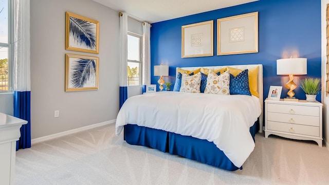 carpeted bedroom featuring baseboards