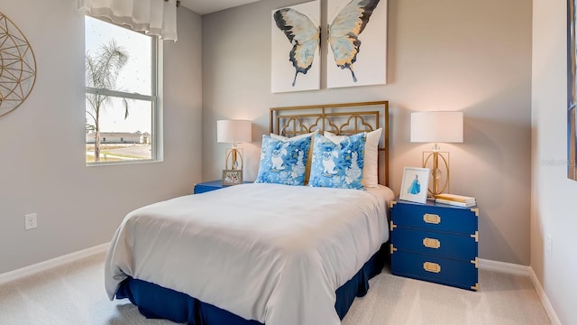 carpeted bedroom featuring baseboards