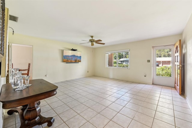 interior space with light tile patterned floors, ceiling fan, and visible vents