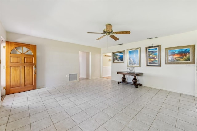 empty room featuring visible vents, ceiling fan, and baseboards