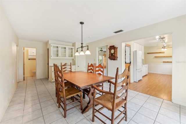 dining area with visible vents, ceiling fan, and light tile patterned floors