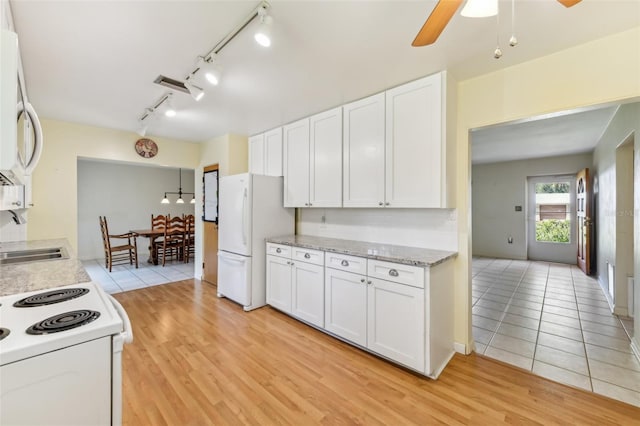 kitchen featuring a sink, white appliances, white cabinets, and light wood finished floors