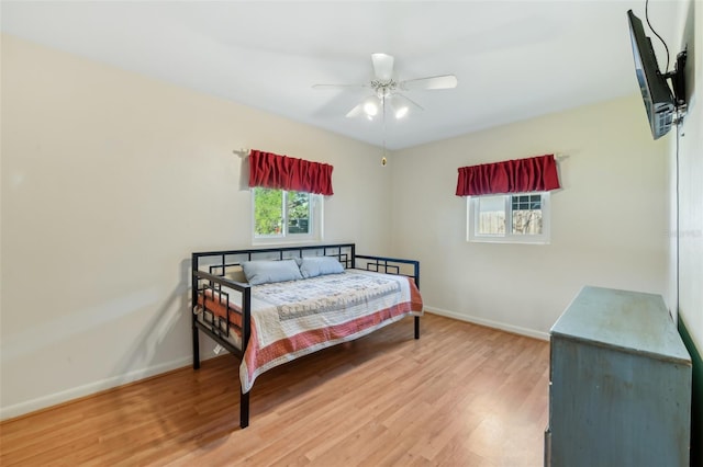 bedroom featuring ceiling fan, wood finished floors, and baseboards