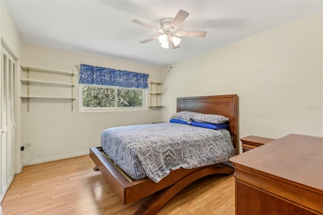 bedroom with a closet, light wood-type flooring, a ceiling fan, and baseboards