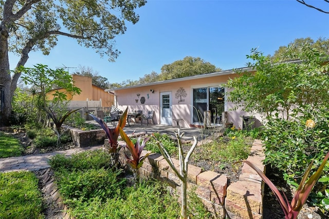 back of property featuring a patio area and fence