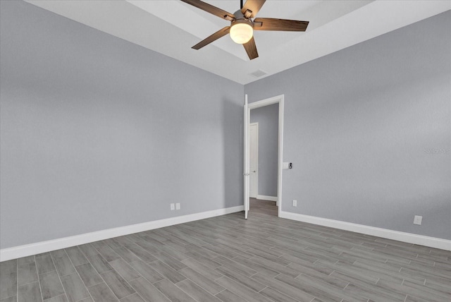 unfurnished room with wood finished floors, ceiling fan, baseboards, and visible vents