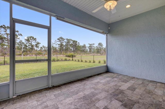 unfurnished sunroom featuring ceiling fan
