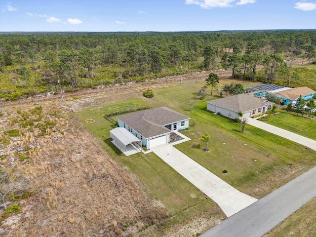drone / aerial view with a wooded view
