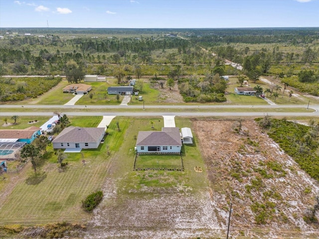 bird's eye view with a wooded view