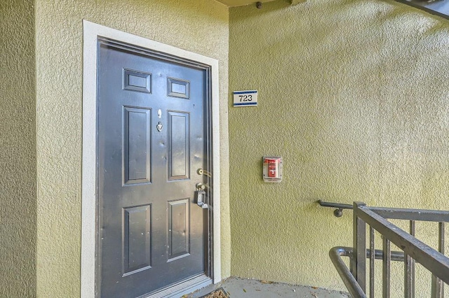 property entrance with stucco siding