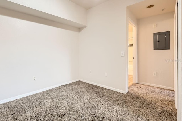 empty room with baseboards, electric panel, and carpet flooring