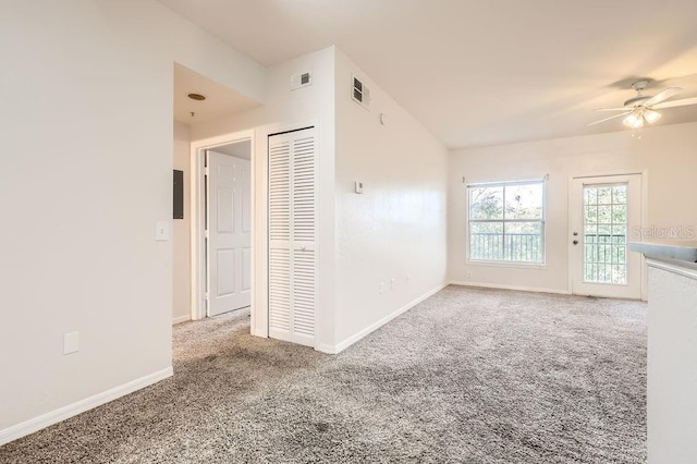 spare room featuring a ceiling fan, carpet, visible vents, and baseboards