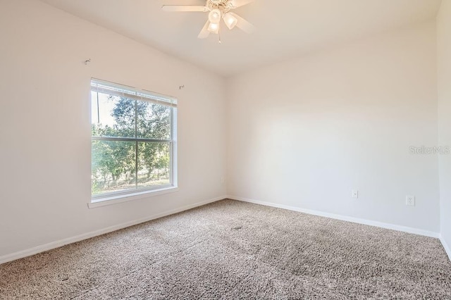 unfurnished room featuring carpet floors, ceiling fan, and baseboards