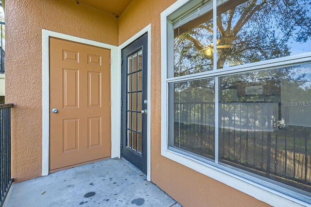 property entrance with stucco siding