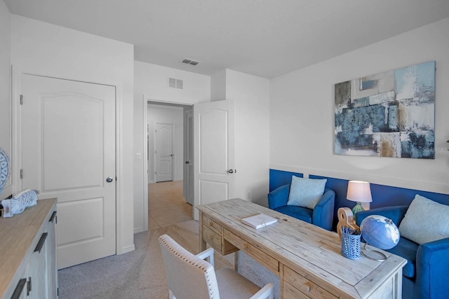 office area with visible vents and light colored carpet