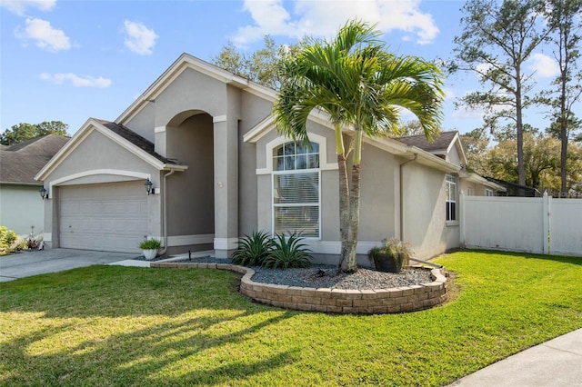 view of front of home with fence, an attached garage, stucco siding, a front lawn, and concrete driveway