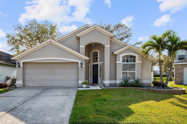 view of front facade with stucco siding, concrete driveway, and a front yard