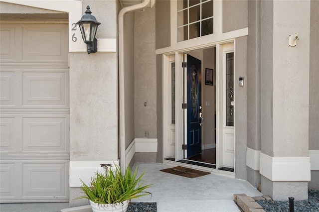 view of exterior entry with stucco siding