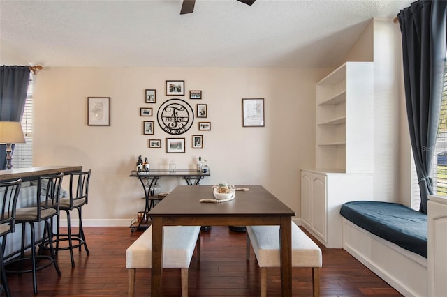 dining space with baseboards, a textured ceiling, ceiling fan, and dark wood-style flooring