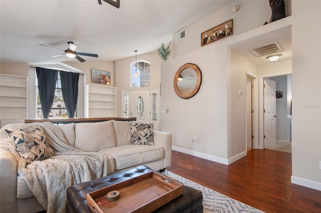 living area featuring visible vents, baseboards, and wood finished floors