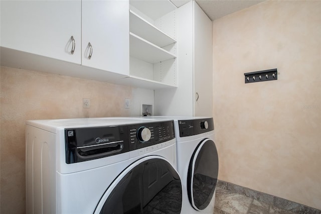 laundry room featuring washer and dryer and cabinet space