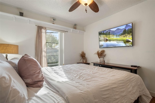 bedroom with ceiling fan and a textured ceiling