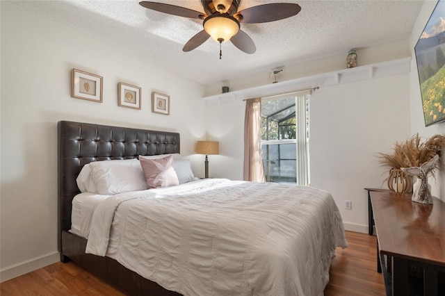 bedroom with a textured ceiling, a ceiling fan, baseboards, and wood finished floors