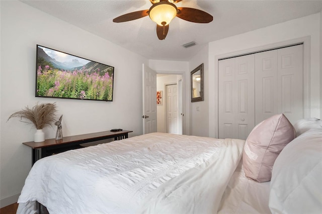 bedroom with visible vents, a closet, and ceiling fan