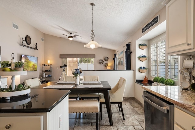 dining space with visible vents, baseboards, vaulted ceiling, a textured ceiling, and a ceiling fan